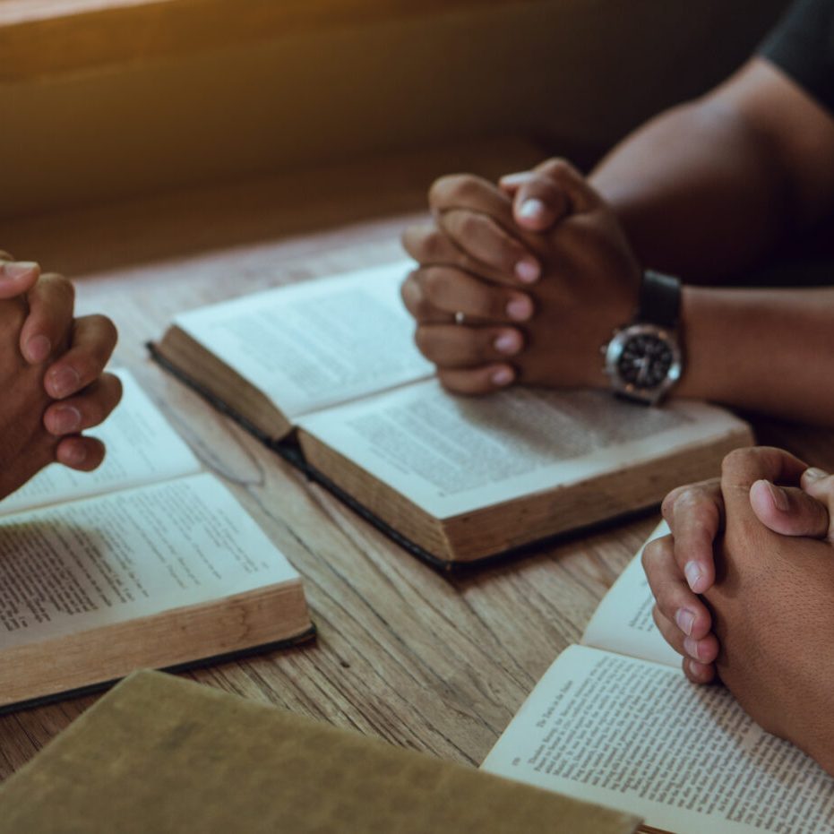 Group of christian people reading and study bible in home and pray together.people hands praying worship god.Diverse religious shoot.